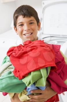 Royalty Free Photo of a Boy Doing Laundry
