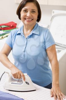 Royalty Free Photo of a Woman Ironing