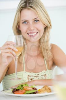 Royalty Free Photo of a Girl Having Wine With Dinner
