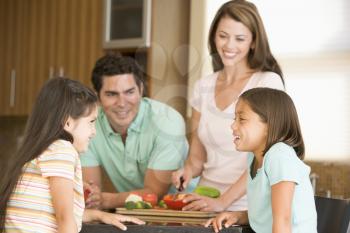 Royalty Free Photo of a Family Preparing a Meal