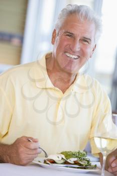 Royalty Free Photo of a Man Having Wine and a Salad