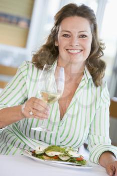 Royalty Free Photo of a Woman Having a Glass of Wine With Dinner