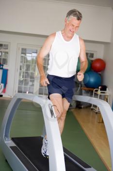 Royalty Free Photo of a Man Running on a Treadmill