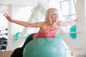 Royalty Free Photo of a Woman Balancing on a Ball