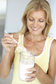 Royalty Free Photo of a Woman Mixing a Supplement