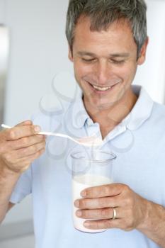 Royalty Free Photo of a Man Mixing a Supplement