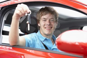 Royalty Free Photo of a Teenage Boy in a Car Holding Keys