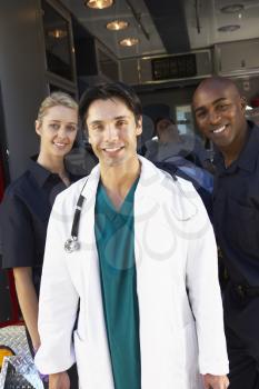 Royalty Free Photo of Paramedics and a Doctor in Front of an Amublance