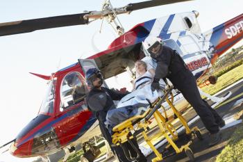 Royalty Free Photo of a Patient Being Unloaded From a Helicopter