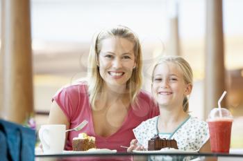 Royalty Free Photo of a Mother and Daughter Having Cake at a Mall