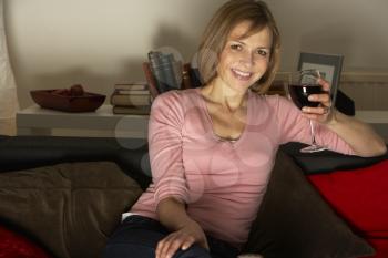 Royalty Free Photo of a Woman Watching TV With Wine