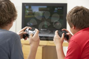 Royalty Free Photo of Two Boys Playing a Video Game