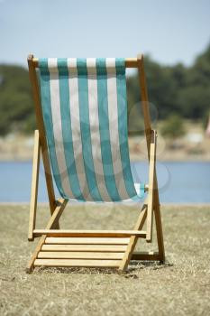 Royalty Free Photo of a Chair Near the Water