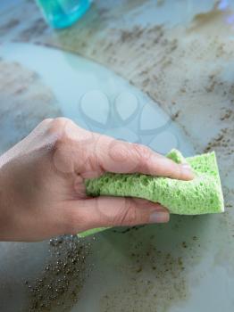 Royalty Free Photo of a Sponge Cleaning Dirt Off a Counter