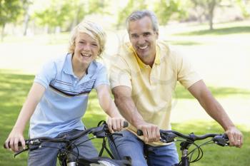 Royalty Free Photo of a Father and Son on Bikes