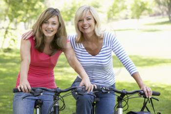 Royalty Free Photo of a Mother and Daughters on Bikes