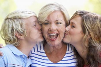 Royalty Free Photo of a Woman Being Kissed by Her Children