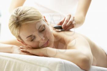 Royalty Free Photo of a Young Woman Getting a Hot Stone Massage