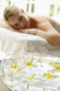 Royalty Free Photo of a Woman on a Massage Table With Flowers in the Foreground