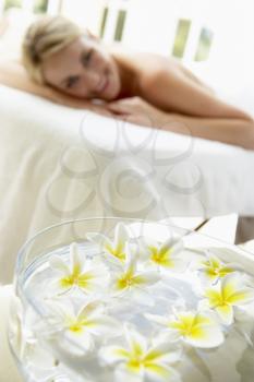 Royalty Free Photo of a Woman on a Massage Table With Flowers in the Background