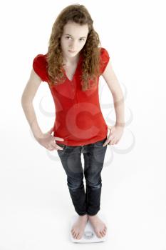 Royalty Free Photo of a Girl on Bathroom Scales