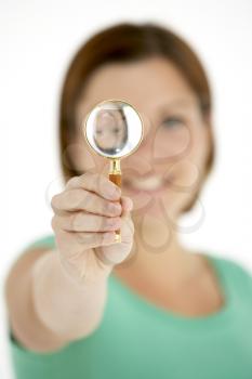 Royalty Free Photo of a Woman Holding a Magnifying Glass