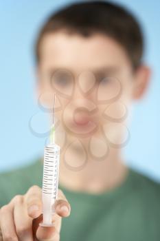 Royalty Free Photo of a Boy With a Syringe