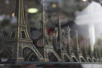 Royalty Free Photo of Eiffel Tower Models in a Shop Window