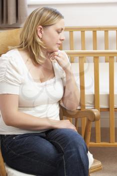 Royalty Free Photo of a Sad Mother in a Nursery