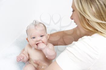 Royalty Free Photo of a Mother Bathing Her Baby