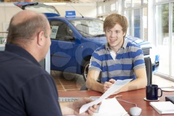 Royalty Free Photo of a Young Man Buying a Car
