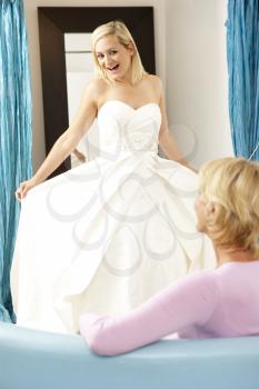 Royalty Free Photo of a Bride Trying on a Bridal Gown