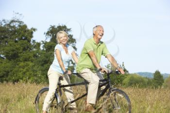 Royalty Free Photo of a Couple on a Tandem Bike