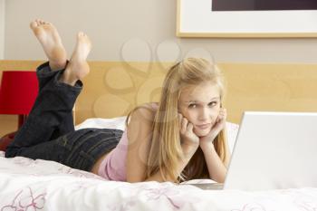 Royalty Free Photo of a Girl in a Room With a Laptop