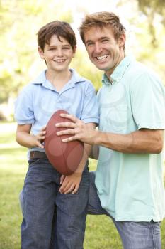 Royalty Free Photo of a Father and Son With a Football