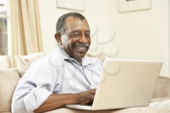 Royalty Free Photo of a Man at Home on a Computer