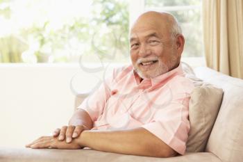 Royalty Free Photo of an Older Asian Man in a Chair