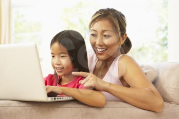 Royalty Free Photo of a Mother and Daughter With a Computer
