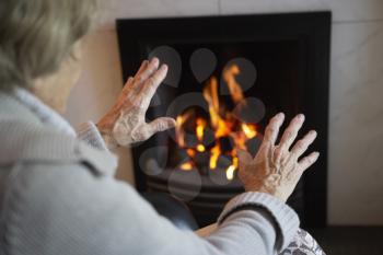 Royalty Free Photo of a Person Warming Their Hands at a Fire