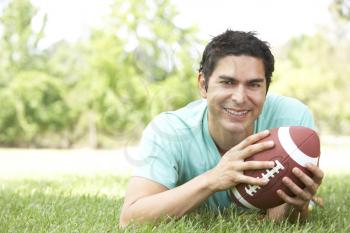 Royalty Free Photo of a Man Outside With a Football
