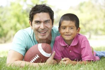 Royalty Free Photo of a Father and Son With a Football
