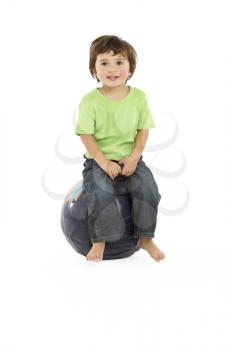 Young Boy Having Fun On Inflatable Hopper