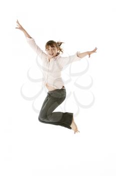 Studio Shot Of Young Girl Jumping In Studio