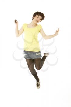 Studio Portrait Of Teenage Girl Jumping In Air