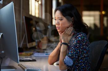 Stressed Female Designer Works At Computer In Modern Office