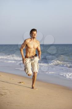 Young Man Running Along Summer Beach