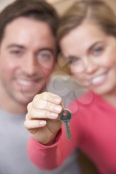 Young couple holding key in hand