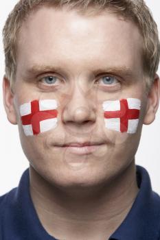 Young Male Sports Fan With St Georges Flag Painted On Face