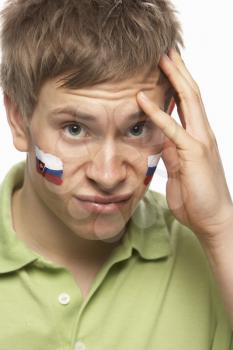 Disappointed Young Male Sports Fan With Slovakian Flag Painted On Face