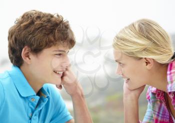 Teenage girl and boy head and shoulders in profile